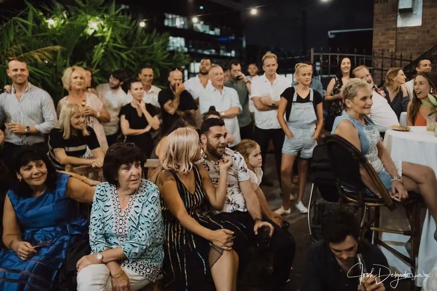 Guests gathered together enjoying live interactive magic